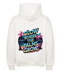 Premium Oversized Hoodie „Glow Where the Palms Grow“ von TeeTreeTrendz mit tropischem Palmen-Design, Neon-Schriftzug und Retro-Sonnenuntergang in vibranten Farben