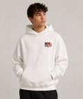Weißer Oversized Hoodie mit kleinem MOVE DIFFERENT Frontprint und großem NOT HERE TO FIT IN Backprint in Rot und Schwarz.